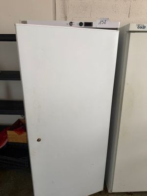 two refrigerators sitting next to each other in a room