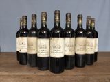 six bottles of wine sitting on top of a wooden table