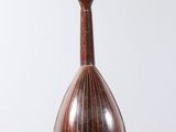 an image of a mandolin hanging from a string on a white background