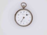 an antique pocket watch on a white surface with a white background