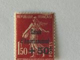 a red stamp with a picture of a woman on it