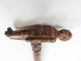 a wooden statue of a man laying on a table