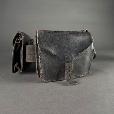 a black leather purse with a metal clasp on it