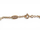 an image of a gold chain bracelet with a pearl bead on it