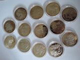 several different coins are arranged in a circle on a white surface