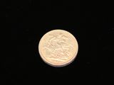 a close up of a coin on a black surface