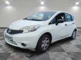 a picture of a small white car parked on a checkered floor