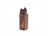 a small statue of a man and a dog on a stand