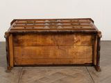 an old wooden chest sitting on top of a floor next to a white wall