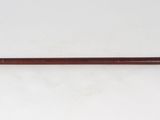 a close up of a cane with a handle on a white surface