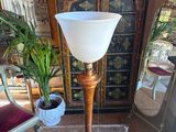 a glass table with a lamp on it in a living room
