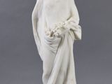 statue of a woman holding a basket of flowers