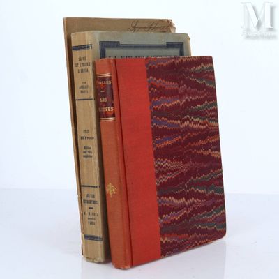 three books are stacked on top of each other on a table