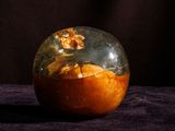 an apple that has been covered with a glass cover