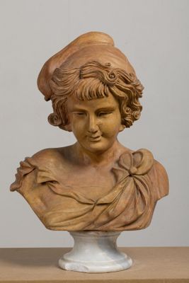 a bust of a woman with a hat on top of a table