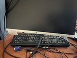 an image of a computer monitor and keyboard on a desk