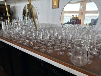 many wine glasses lined up on a table