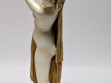 an image of a statue of a woman holding a bird in her hand