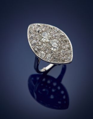 a close up of a diamond ring on a blue surface