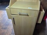 a wooden cabinet with a drawer on it in a room