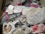 a cardboard box full of clothes and other items