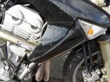 a close up of a motorcycle parked in a parking lot
