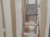 a ladder that is leaning against a wall in a room