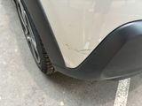a close up of a car ' s front bumper and tire