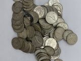 a pile of silver coins on a white surface