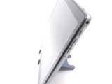 a tablet computer sitting on a stand on a white surface