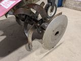 a tractor with a plow attached to it ' s back