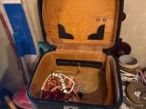 an open suitcase sitting on top of a wooden table
