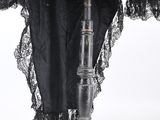 an image of a black dress on a wooden stand with a black lace overlay