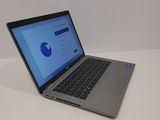a laptop computer sitting on a table with a blue screen
