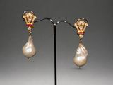 a pair of pearl and gold earrings