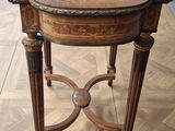 a small table with a wooden top on a wooden floor