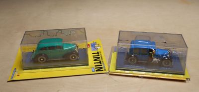 two toy cars that are in a box on a table