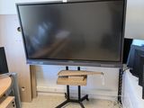 a flat screen tv sitting on a stand in the corner of a room
