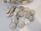 a bag of silver coins sitting on a table next to a bag of silver coins