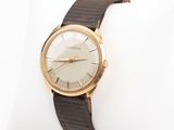 an image of a gold wrist watch on a brown leather band