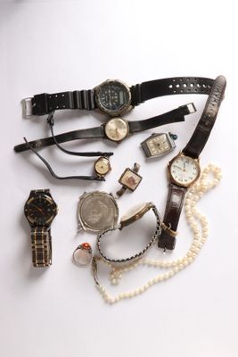 a lot of watches and bracelets on a white surface