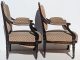 pair of upholstered armchairs with upholstered back and arms