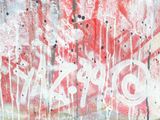 graffiti on the side of a building that has a red and white sign on it
