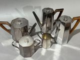 five coffee pots and a teapot on a table