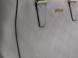 a close up of a purse on a table with a white background