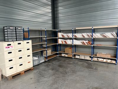 a room with a lot of shelves and boxes in it