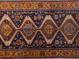 un tapis persan ancien présentant un motif géométrique sur fond bleu