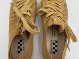 a pair of tan sneakers with laces on them