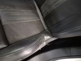 a close up of a car seat with a black leather cover