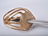 a close up of a metal object with a screw in it